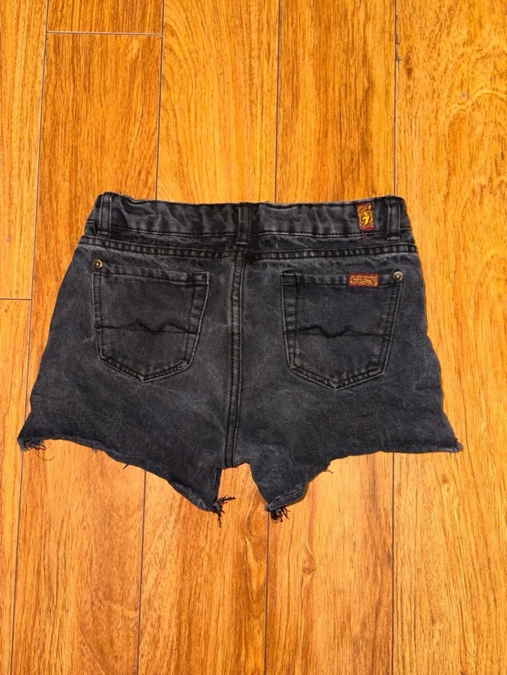 Black denim shorts with a distressed look